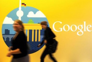 epa03437898 (FILE) A file photo dated 26 September 2012 showing women walking past the company logo in the offices of the subsidiary of Google in Berlin, Germany. Trading in Google shares was halted in New York after company results were made public before the closing bell, 18 October 2012. The company said its third quarter profits fell 20 per cent on a year to 2,18 billion USD, well below analysts' estimates.  EPA/BRITTA PEDERSEN